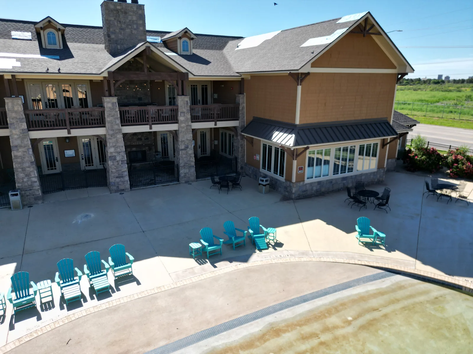 Aerial luxury home stone shingle roof patio