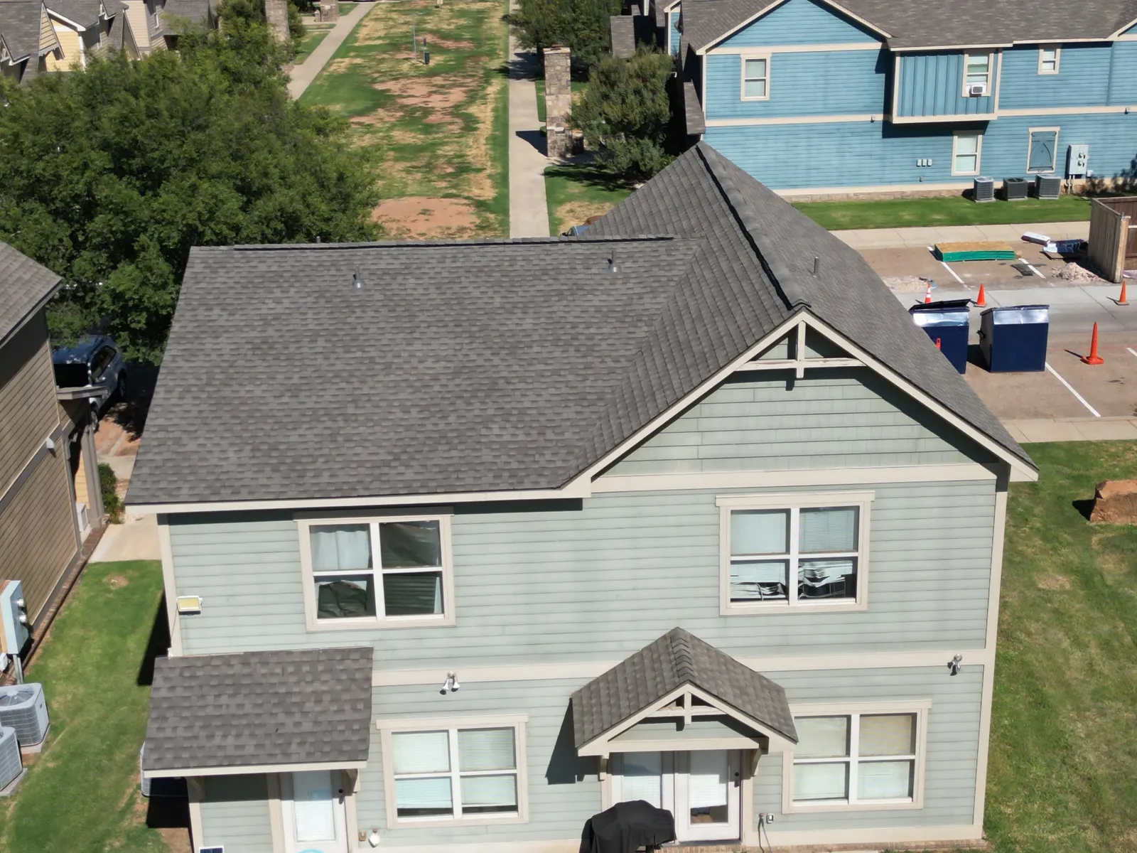 Aerial view completed shingle roof gray home