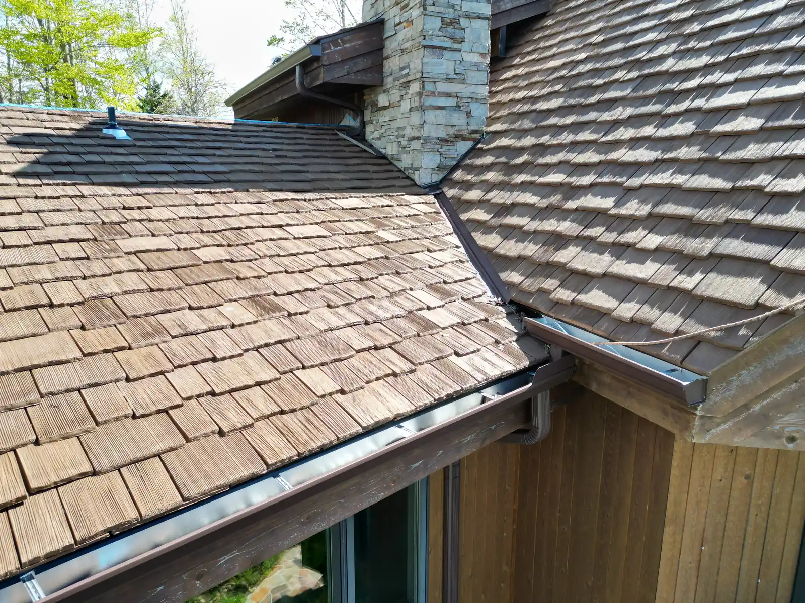 Cedar shake roof stone chimney