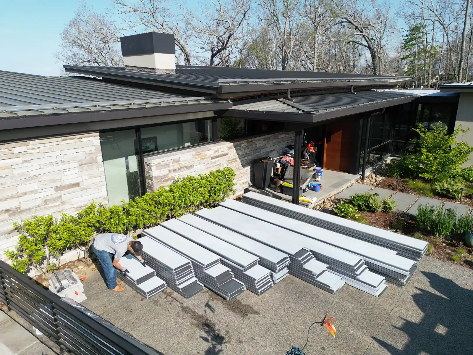 Metal roof panels staged modern home aerial